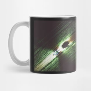 Abstract top down image of farmland and driving tractor Mug